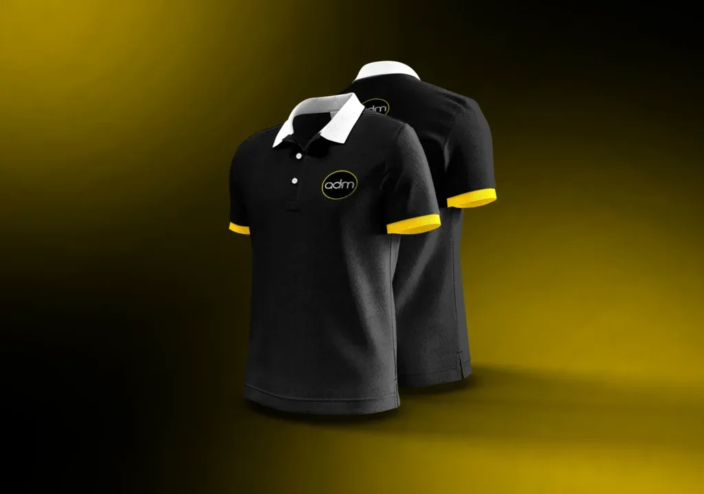 The black ADM polo shirt with yellow cuffs and the ADM disc on the chest, designed in house